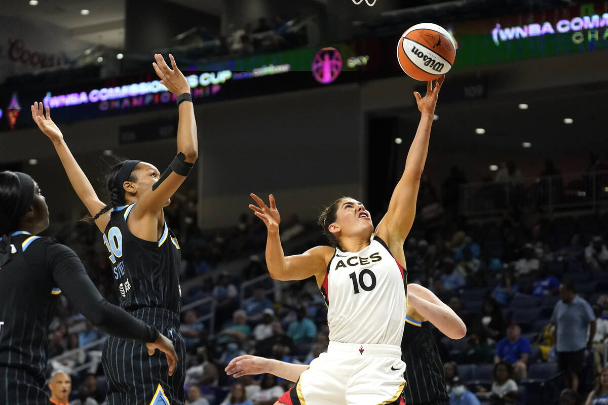 Las Vegas Aces' Kelsey Plum (10) scores past Chicago Sky's Azura Stevens during the first half ...
