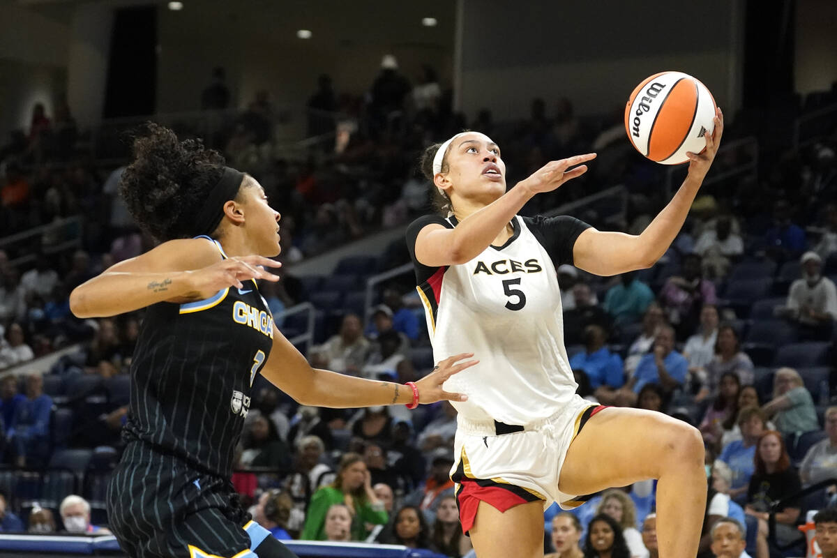 Las Vegas Aces' Dearica Hamby (5) scores past Chicago Sky's Candace Parker during the first hal ...
