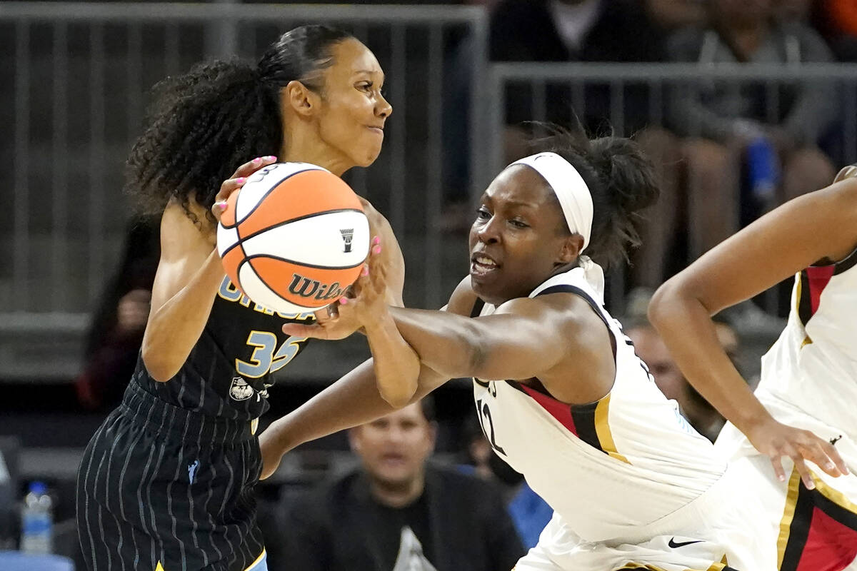 Las Vegas Aces' Chelsea Gray, right, pressures Chicago Sky's Rebekah Gardner during the first h ...