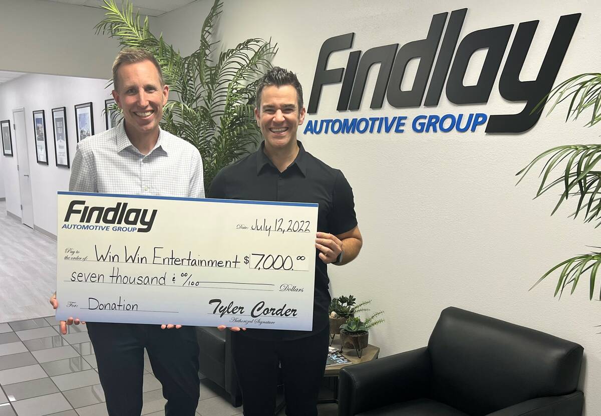 Jeff Giles, left, marketing director of Findlay Automotive, presents a donation check to Jeff C ...