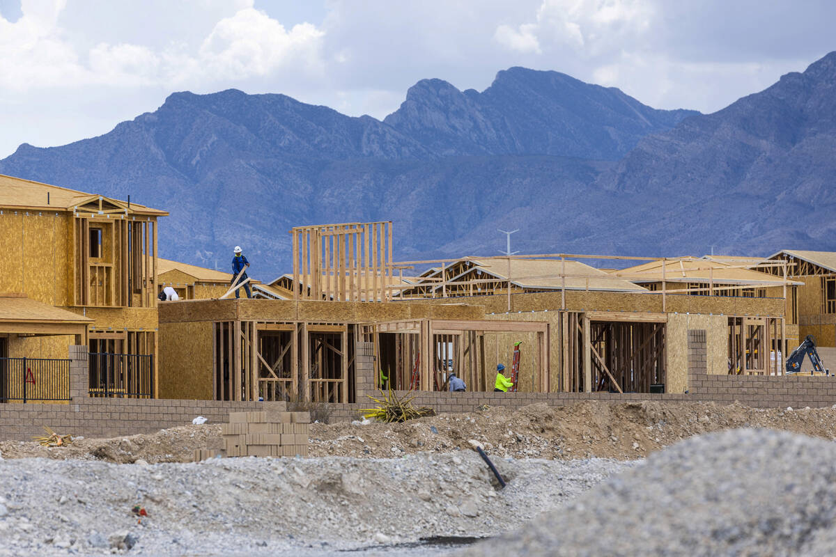 Workers complete framing and walls on new home construction about Skye Canyon on Wednesday, Jul ...