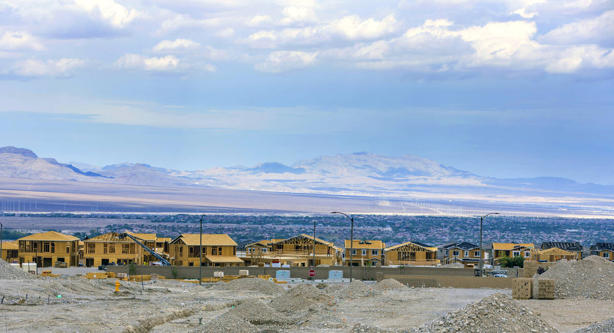 Workers complete framing and walls on new home construction about Skye Canyon on Wednesday, Jul ...