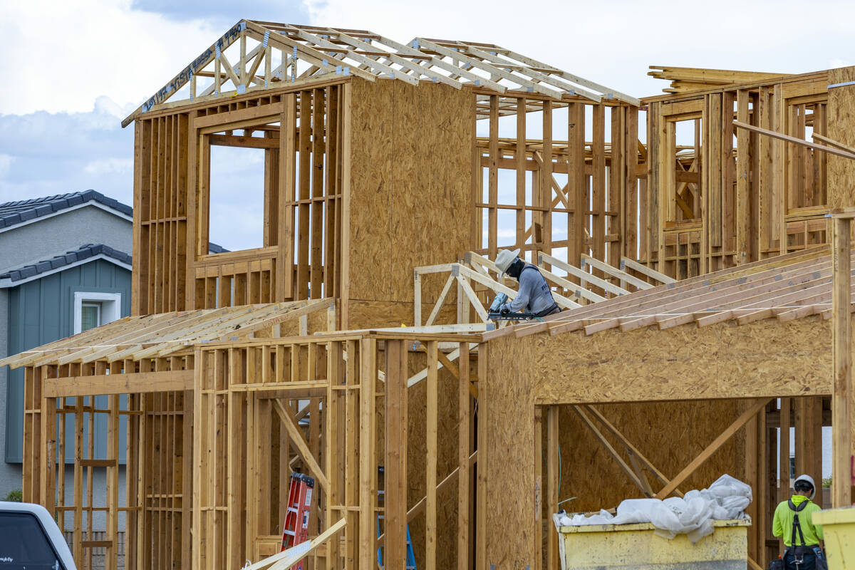 Workers complete framing on new home construction about Skye Canyon on Wednesday, July 27, 2022 ...