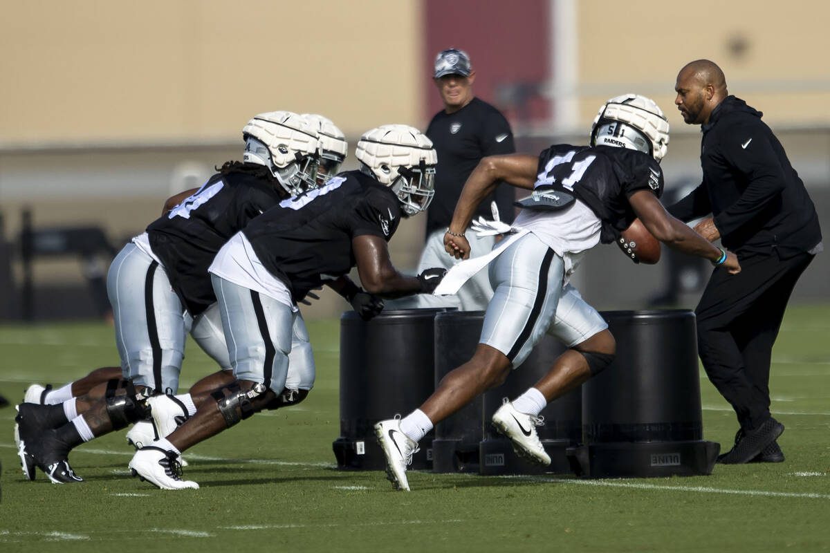 Raiders defensive linemen Vernon Butler (94), Matthew Butler (73) and Malcolm Koonce (51) rush ...