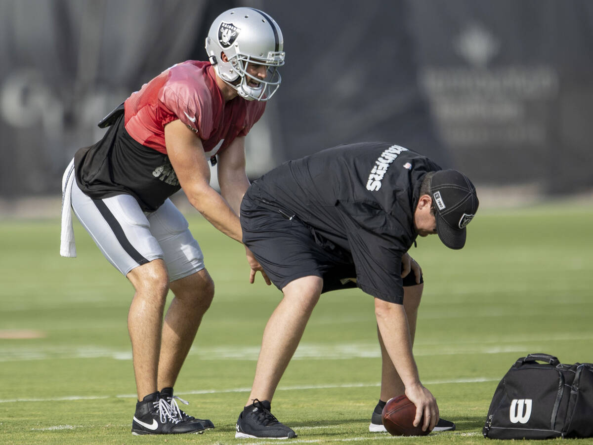 Raiders quarterback Derek Carr (4) takes a snap under center during the team’s training ...