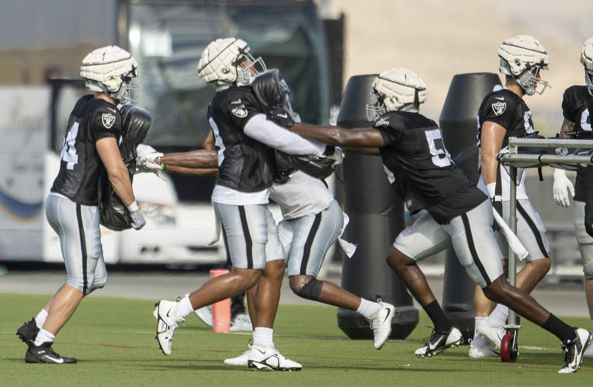 Raiders defensive end Chandler Jones (55), right, works against Raiders defensive end Myron Tag ...