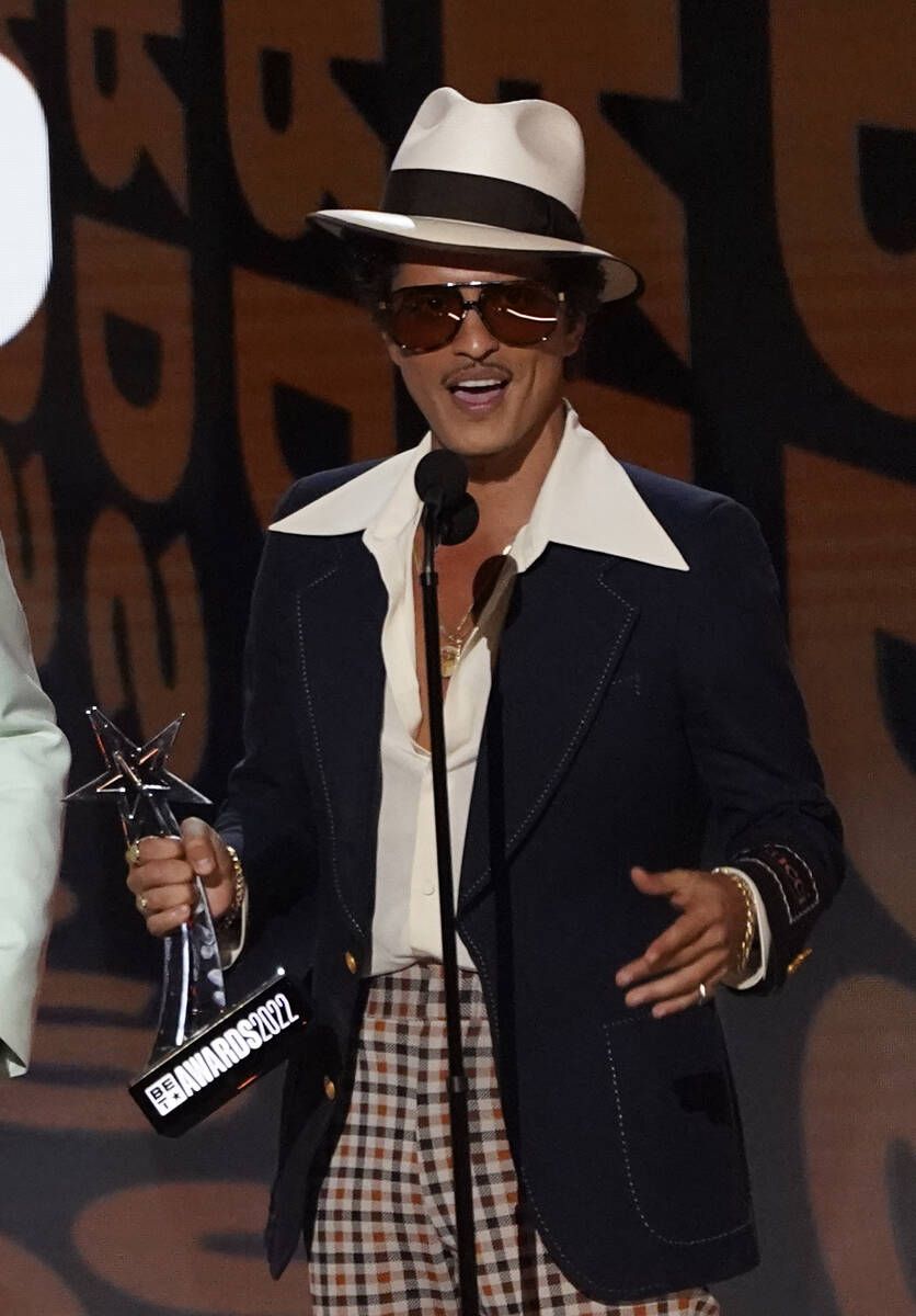 Bruno Mars accepts the award for album of the year for "An Evening with Silk Sonic" a ...
