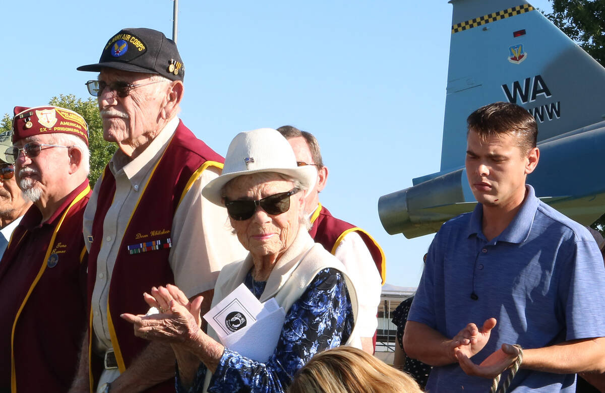 Ex-POW Christopher Yates, right, from the war in Afghanistan, claps during the annual National ...