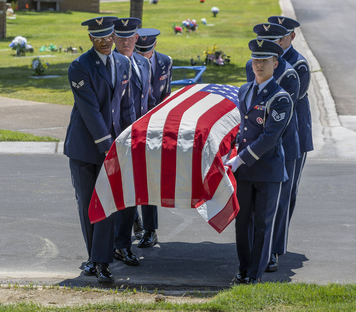The Nellis Air Force Base Honor Guard carries the flag-draped coffin of Southern Nevada WW II v ...