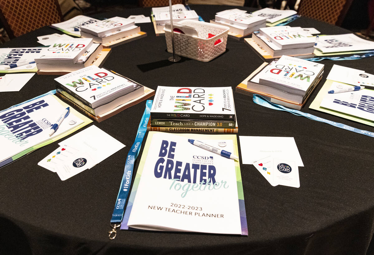 Books and the 2022-2023 new teacher planners are displayed at a new teacher kickoff event at th ...