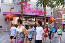 Visitors walk past the Flamingo entrance along The LINQ Promenade as gambling numbers are up on ...