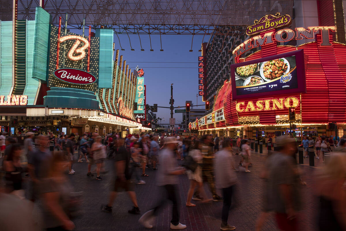 In this June 19, 2022, file photo, people walk around the Fremont Street Experience in downtown ...