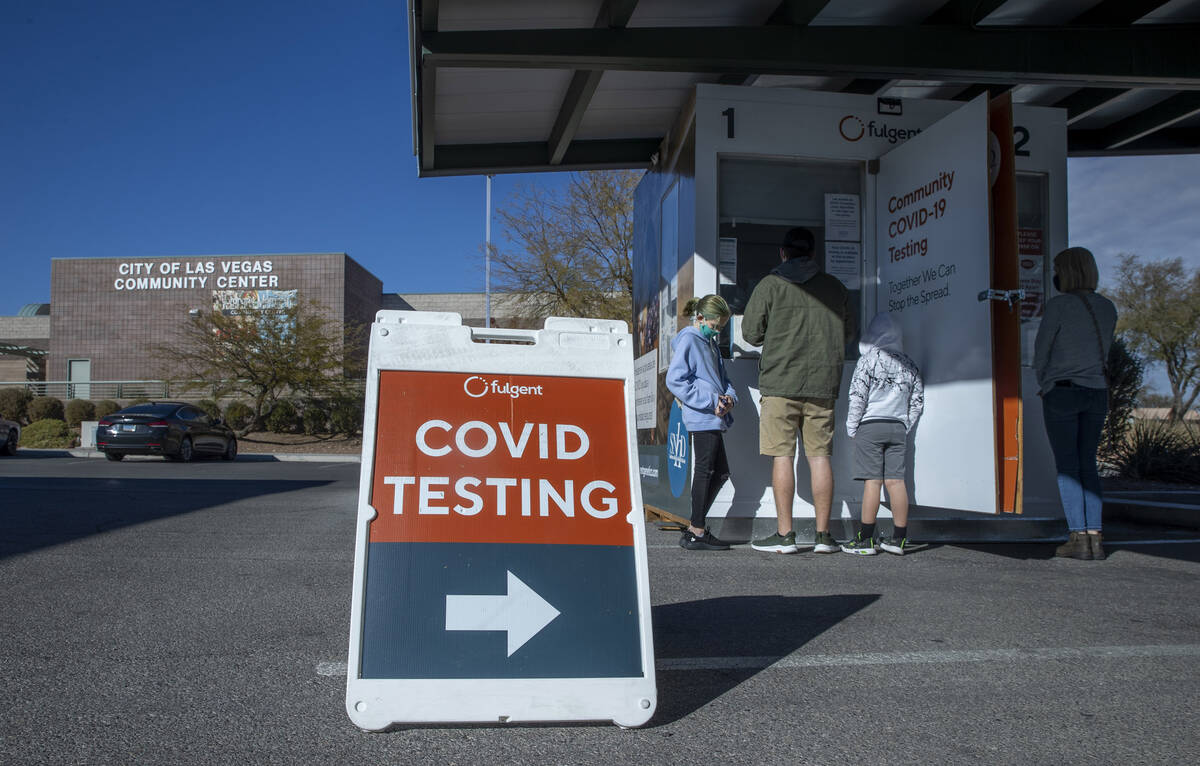 People wait and are served for COVID-19 testing at the Veterans Memorial Community Center on Tu ...