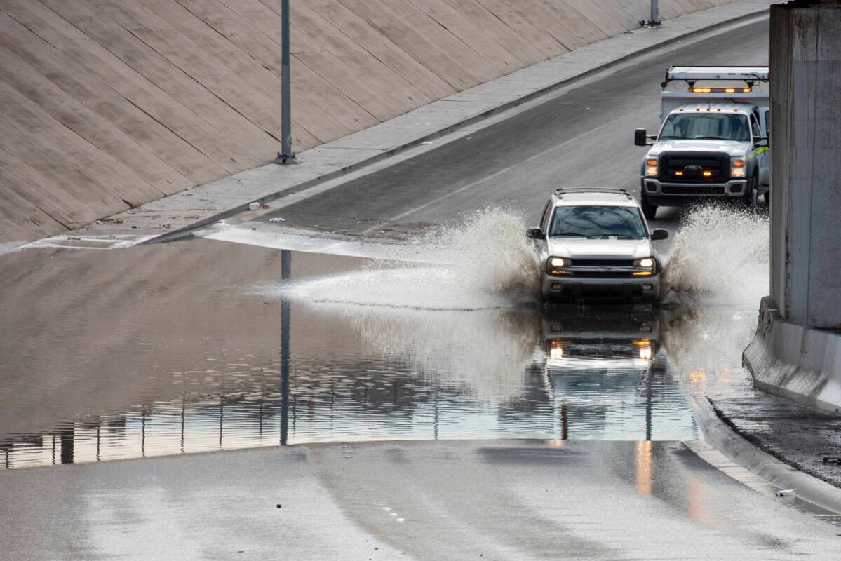 A car drives though floodwaters on West Washington Ave. near North Main St. on Friday, July 29, ...
