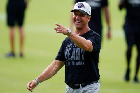 Baltimore Ravens head coach John Harbaugh reacts during the team's NFL football training camp, ...