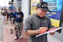 Ro Vill, 33, of Las Vegas fills out his numbers while in line for lottery tickets at the Primm ...