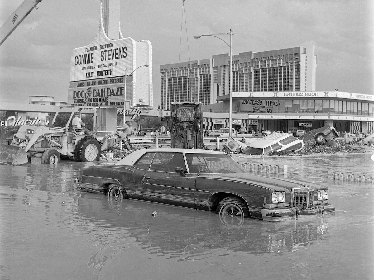 Floodwaters sink cars and fill the Caesars Palace parking lot during a flash flood July 3, 1975 ...