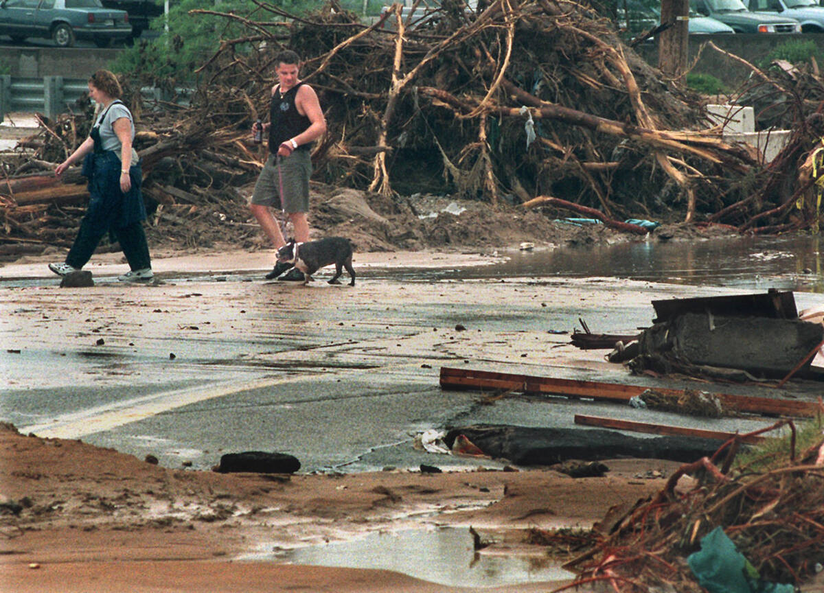 Deana and Ron Bender, residents of the Miracle Mile trailer park, walk near their home along Bo ...