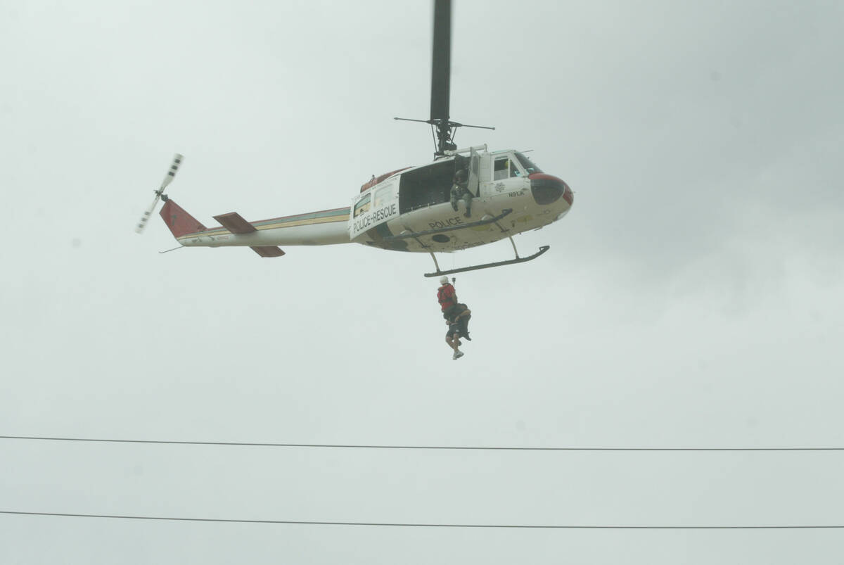 A helicopter rescues people trapped by floodwaters in Las Vegas on Aug. 19, 2003. (Las Vegas Re ...