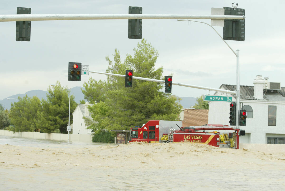 A Las Vegas Fire & Rescue fire truck sits at the flooded intersection of Rainbow Boulevard and ...