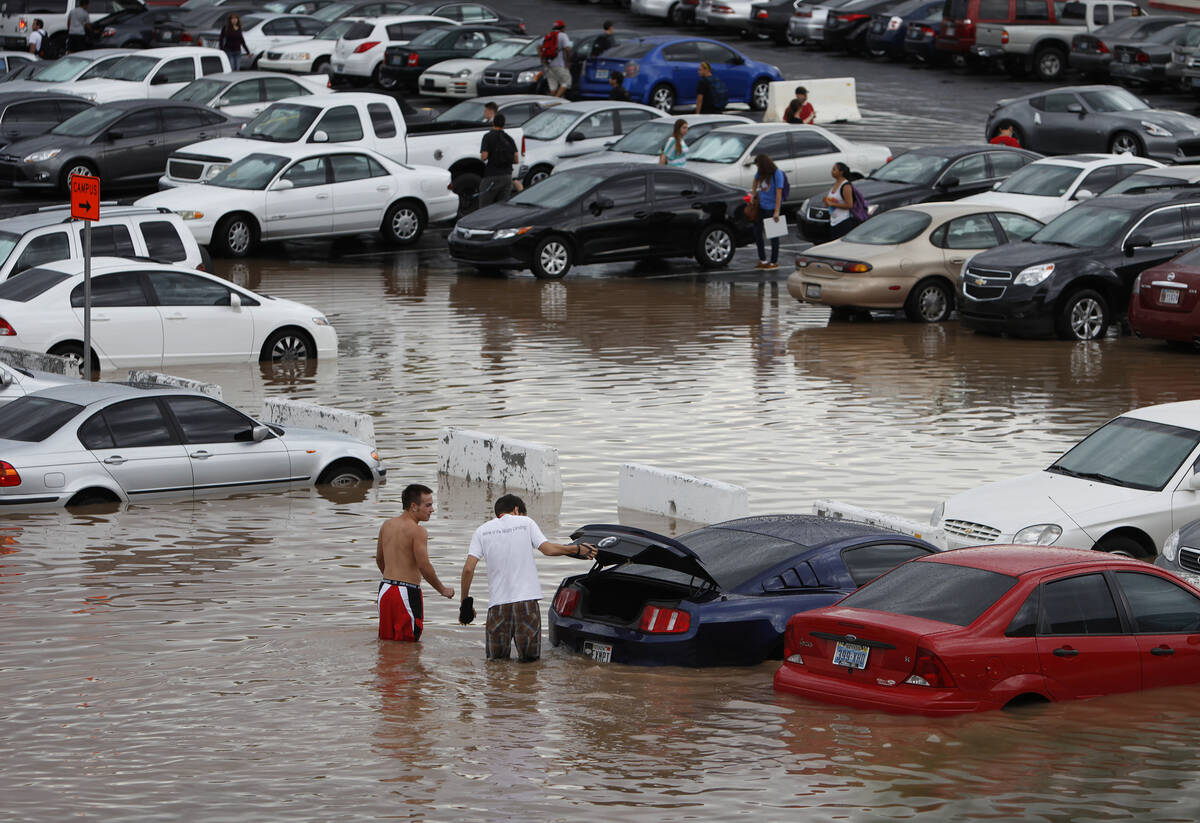 UNLV students walk through floodwaters on the UNLV campus in Las Vegas on Sept. 11, 2012. (AP P ...