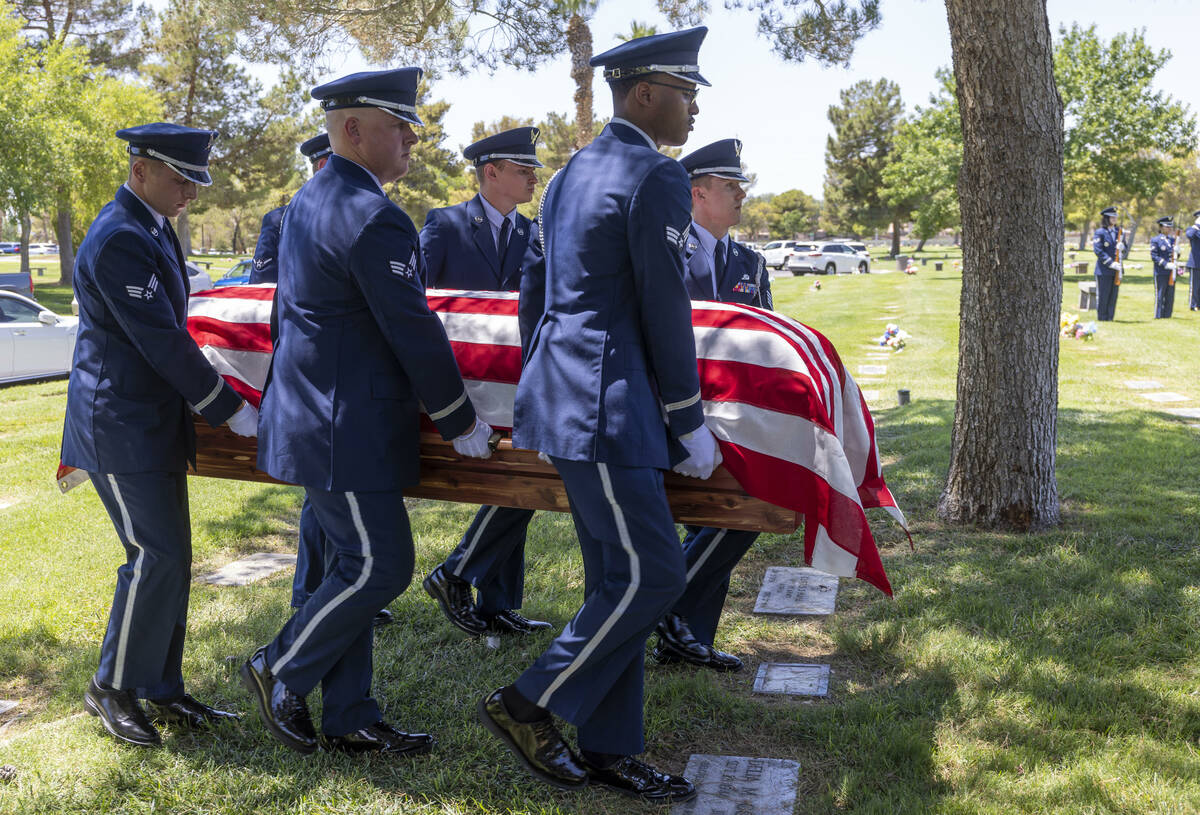 The Nellis Air Force Base Honor Guard carries the flag-draped coffin of Southern Nevada WW II v ...