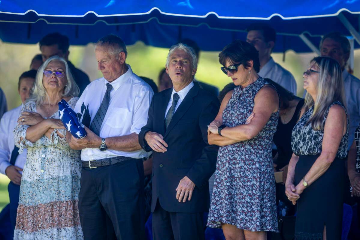 (LtoR) Gerri, Jeff, Michael, Mariana and Nicole Whitaker reflects during the burial service of ...