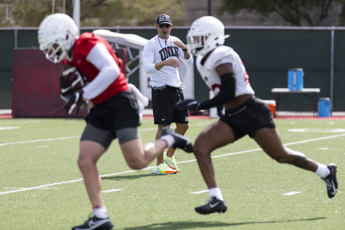 UNLV's football head coach Marcus Arroyo watches his players run drills during a team practice ...
