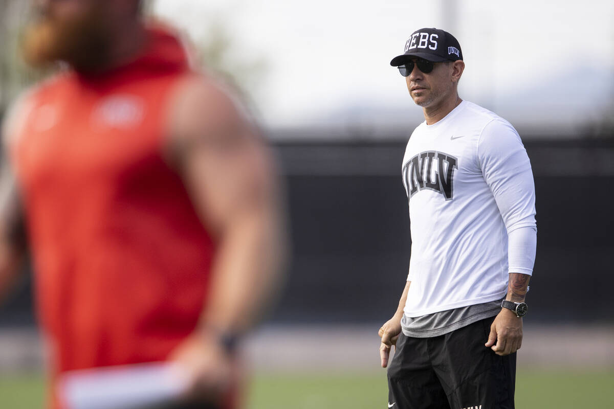 UNLV's football head coach Marcus Arroyo watches his players run drills during a team practice ...