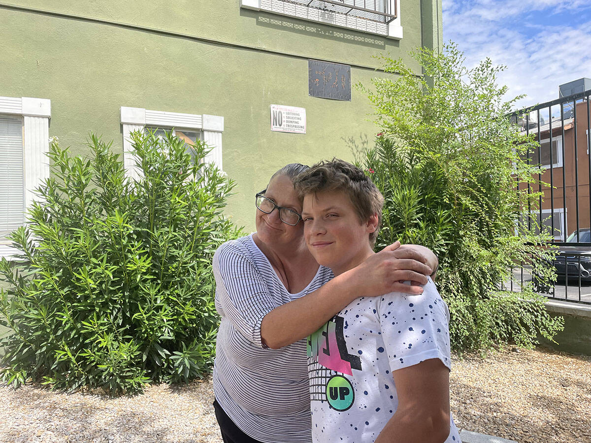 Jeannette Knighton and her son, Sam, stand outside their downtown Las Vegas apartment on July 3 ...