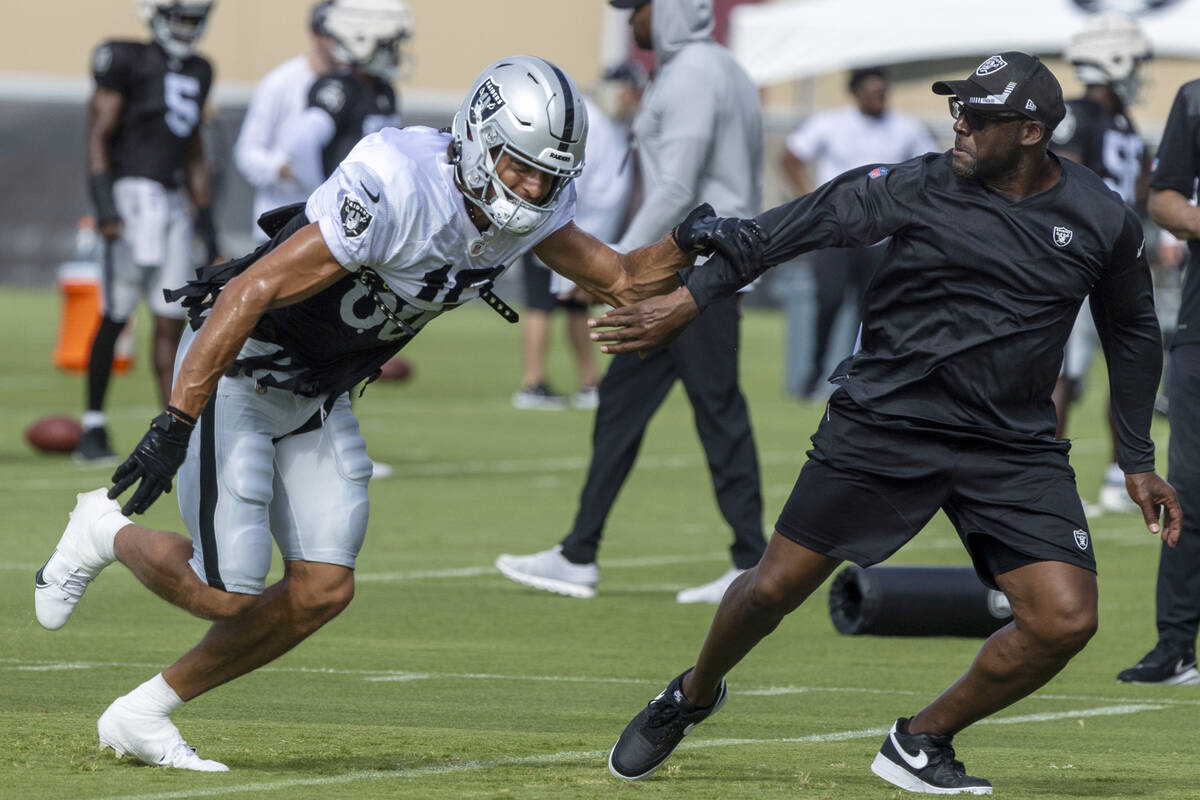 Raiders wide receiver Mack Hollins (10) tries to run past wide receiver coach Edgar Bennett dur ...