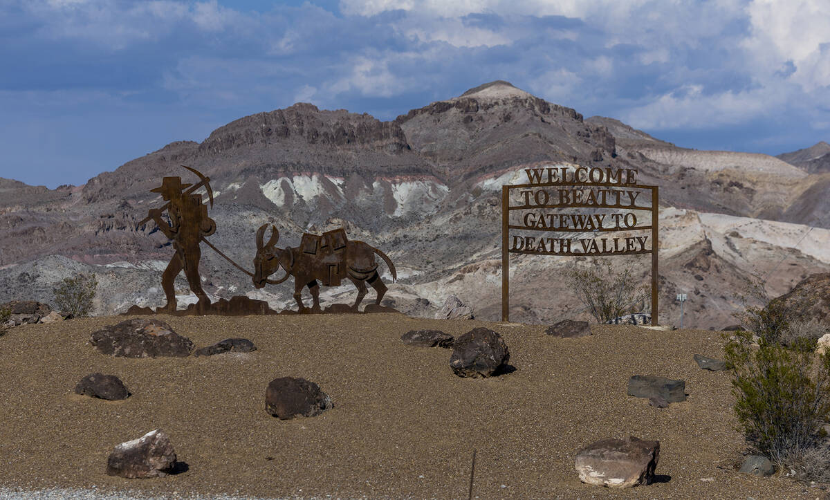 Welcome to Beatty sign greets those coming into town as Beatty Mountain towers behind in the di ...
