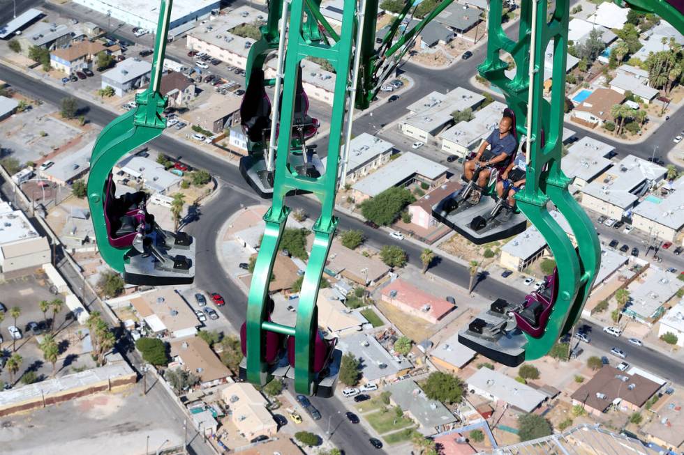 Chi Heon Kim, left, and his son Hanseong Kim, 12, of South Korea, ride Insanity at the Strat ho ...