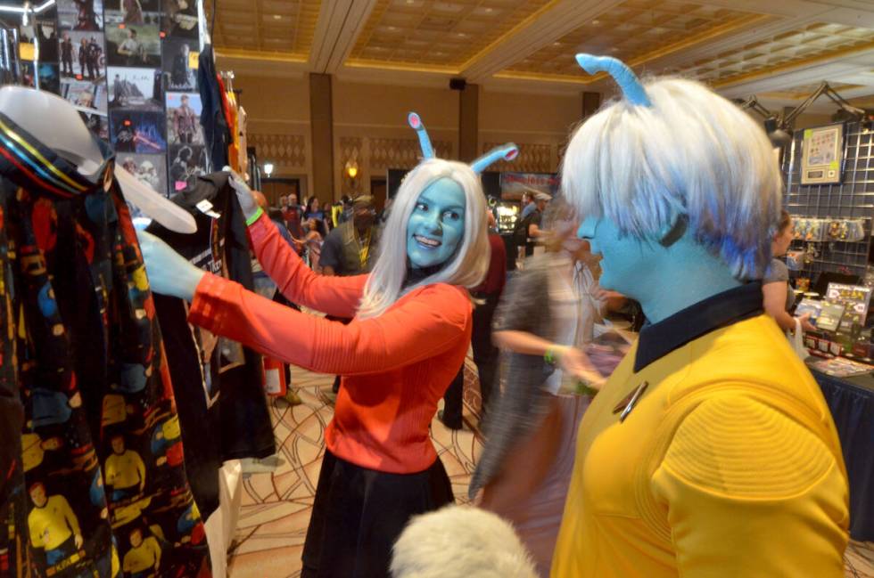 Diana Quake and Tim Harrison, dressed as Andorians, look at a T-shirt during the Star Trek Las ...