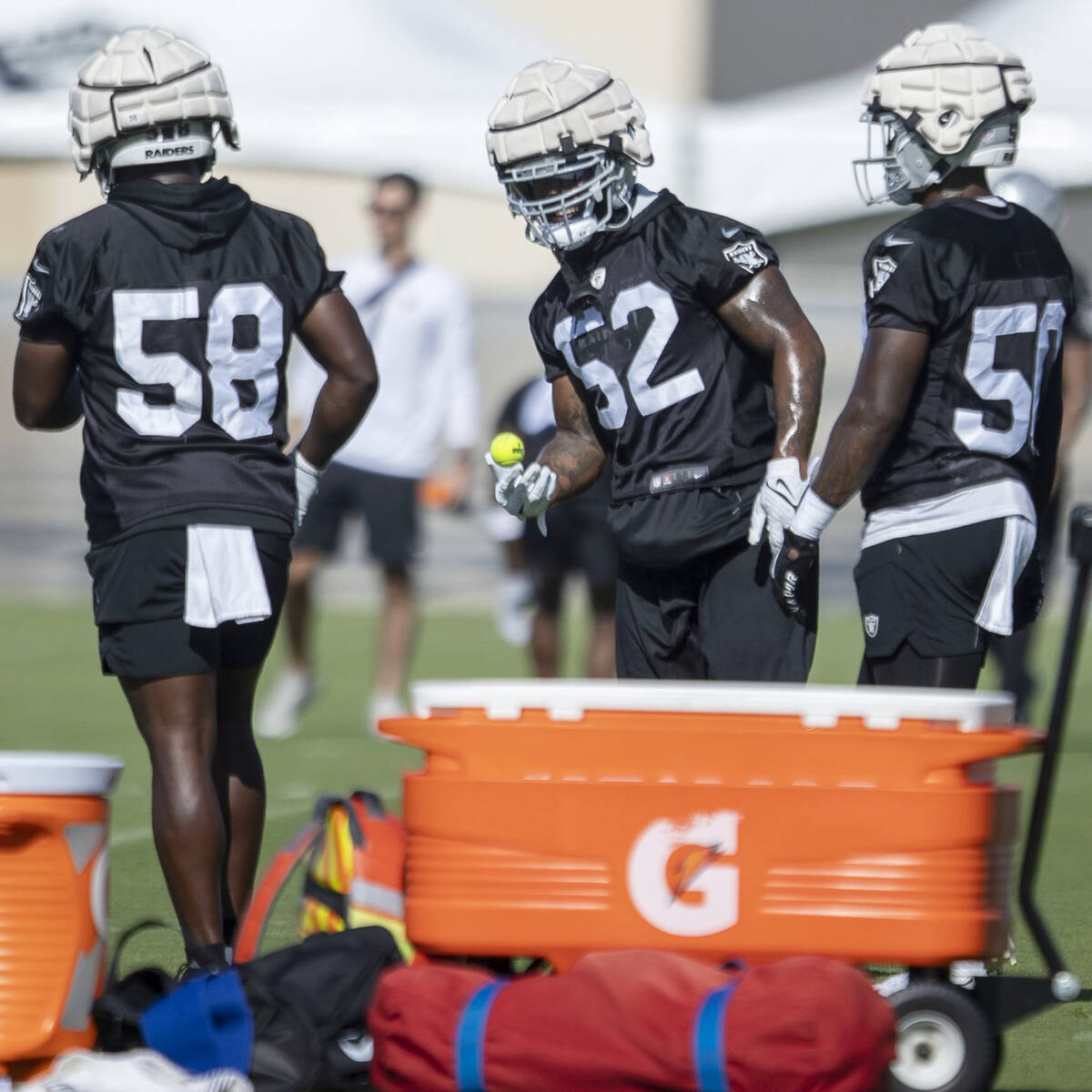 Raiders linebacker Denzel Perryman (52) handles a tennis ball during a drill with linebackers D ...