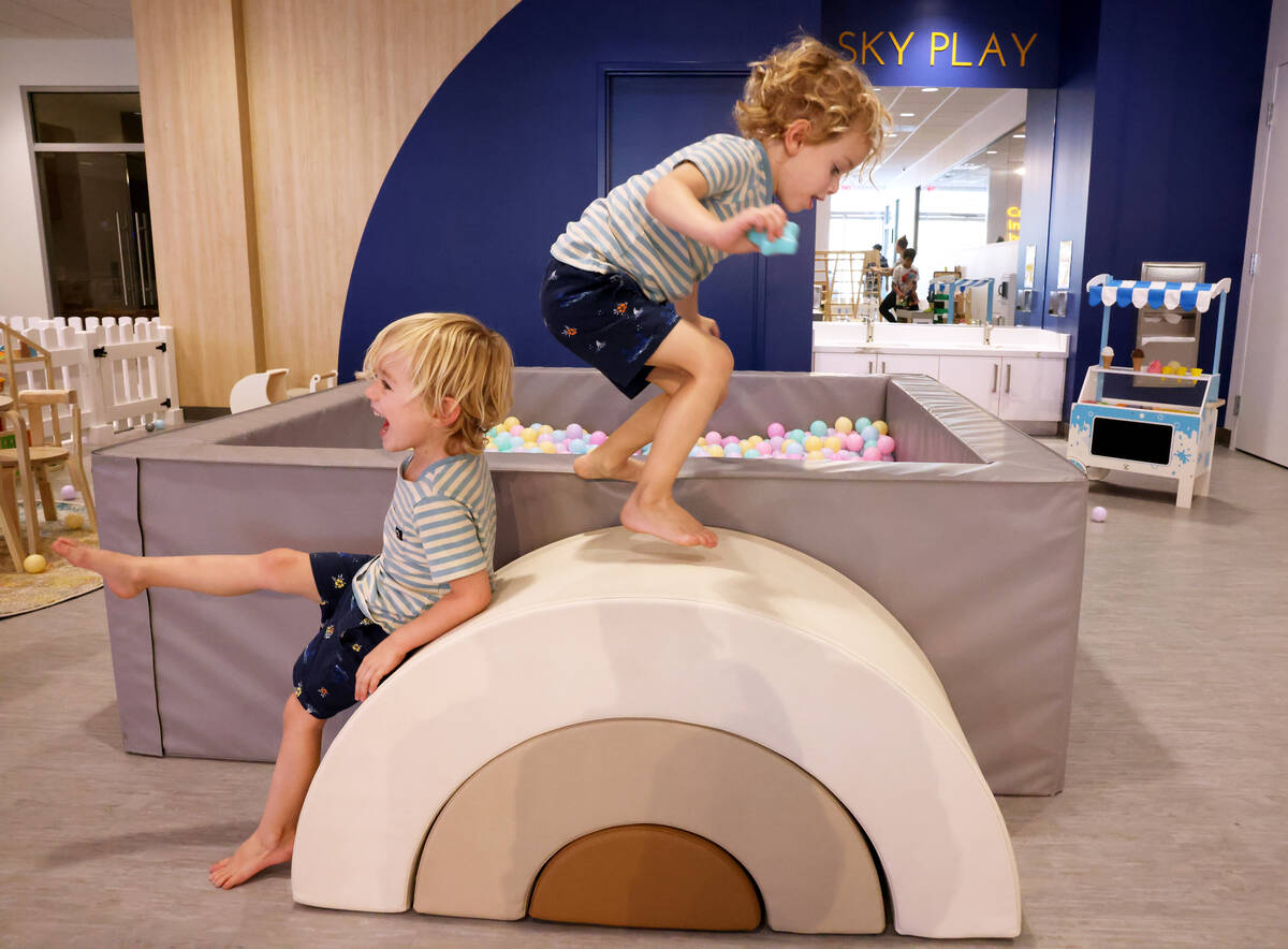 Twins River Camp, left, and Summit Camp, 4, play at the newly opened Skyluna coworking and chil ...