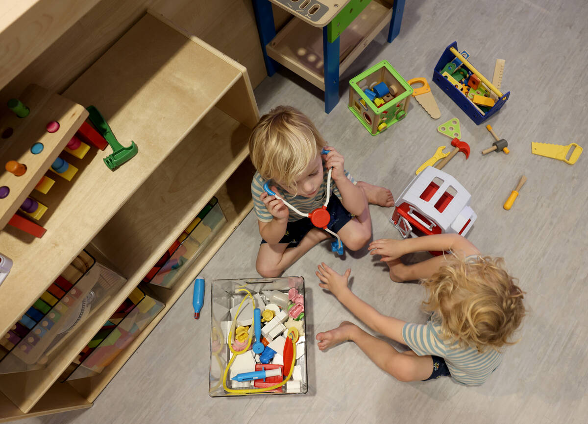 Twins River Camp, left, and Summit Camp, 4, play at the newly opened Skyluna coworking and chil ...