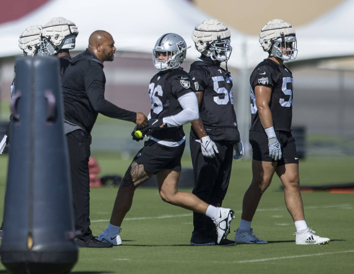 Raiders linebacker coach Antonio Pierce guides linebackers Curtis Bolton III (36), Denzel Perry ...