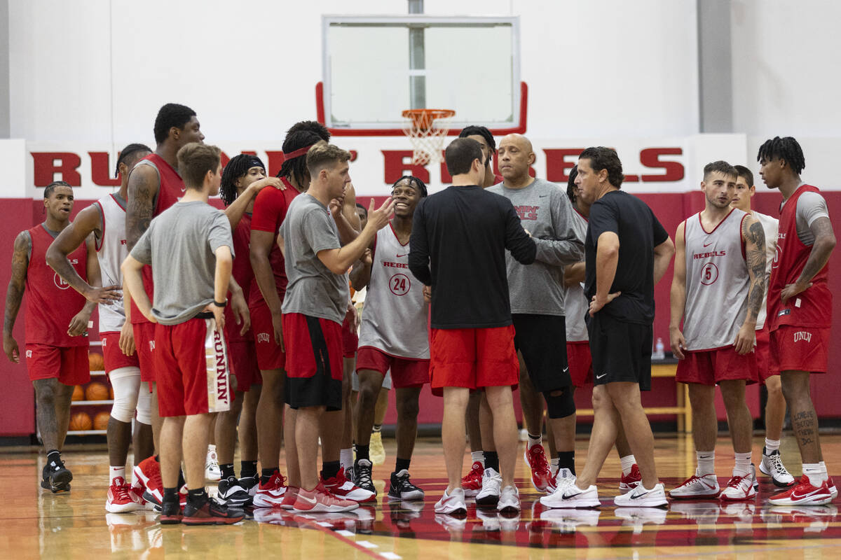 UNLV players huddle with their coaches during a team basketball practice at Mendenhall Center i ...
