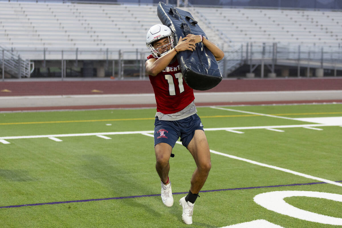 Koi Paaoao runs a drill during a team football practice at Liberty High School in Henderson, Mo ...