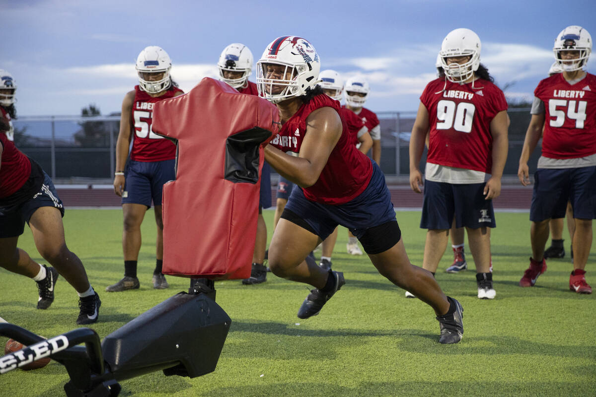 Defensive tackle A.J. Fuimaono runs a drill during a team football practice at Liberty High Sch ...