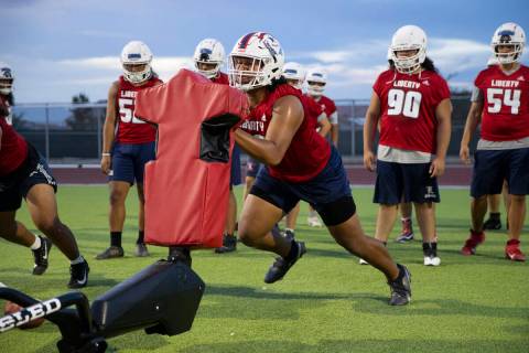 Defensive tackle A.J. Fuimaono runs a drill during a team football practice at Liberty High Sch ...