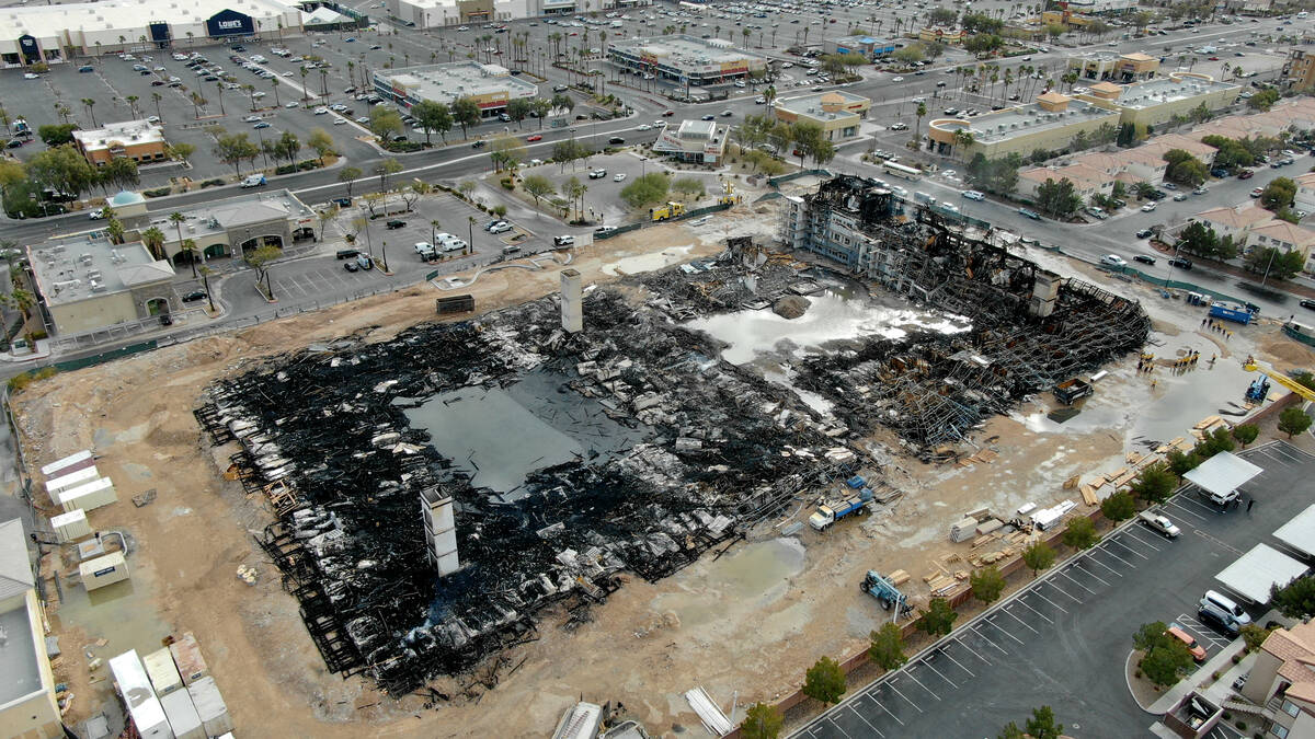 An aerial view of the damage after an overnight fire at an under-construction apartment complex ...