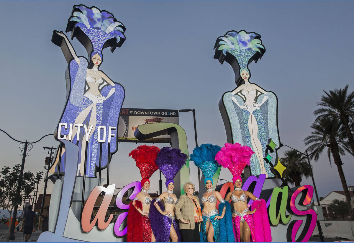 Las Vegas Mayor Carolyn Goodman, third from left, takes photos with a group of showgirls girls ...