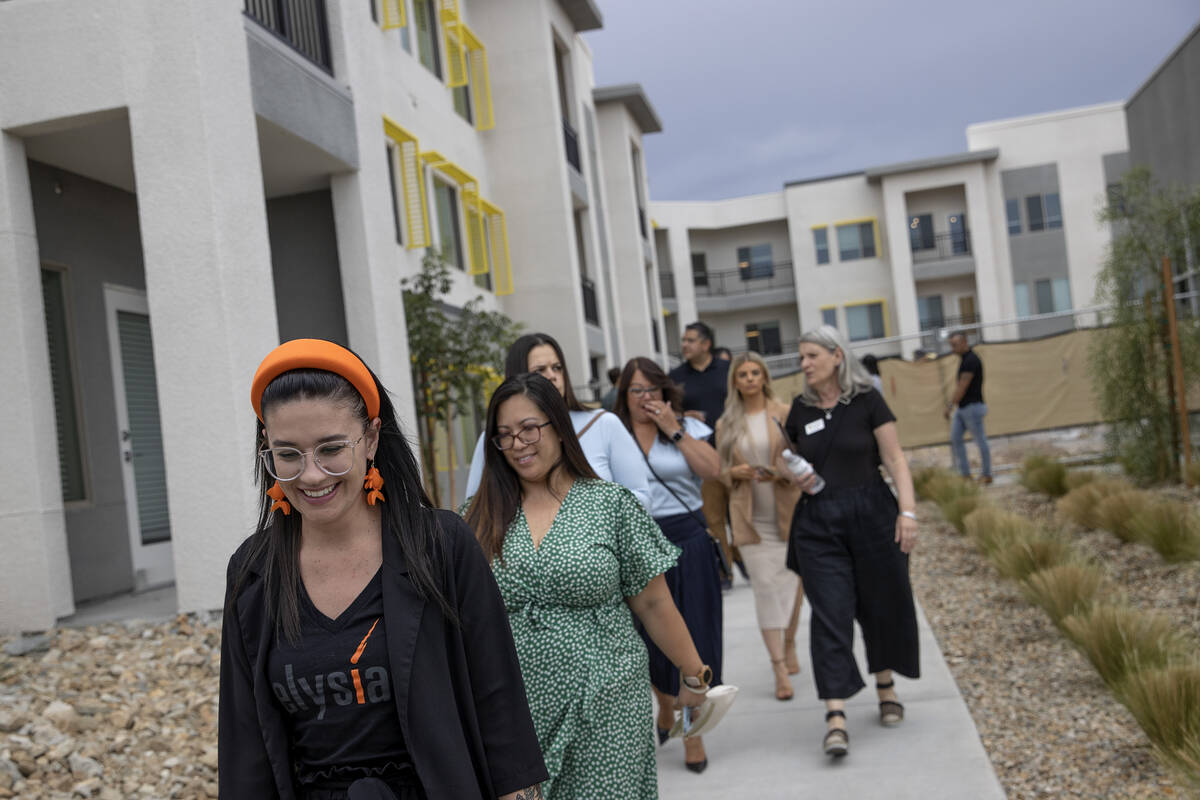 A group takes a tour during an opening event at Ely at Fort Apache apartments on Tuesday, Aug. ...