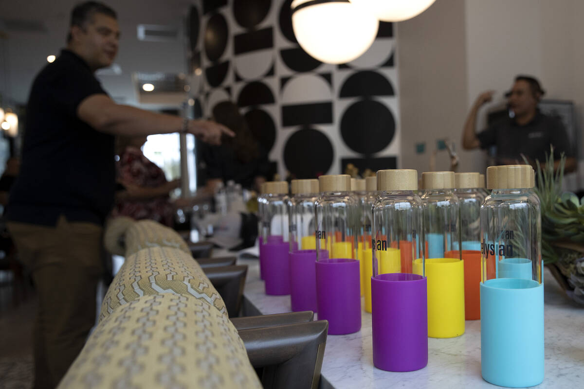 Branded water bottles are up for grabs during an opening event at Ely at Fort Apache apartments ...