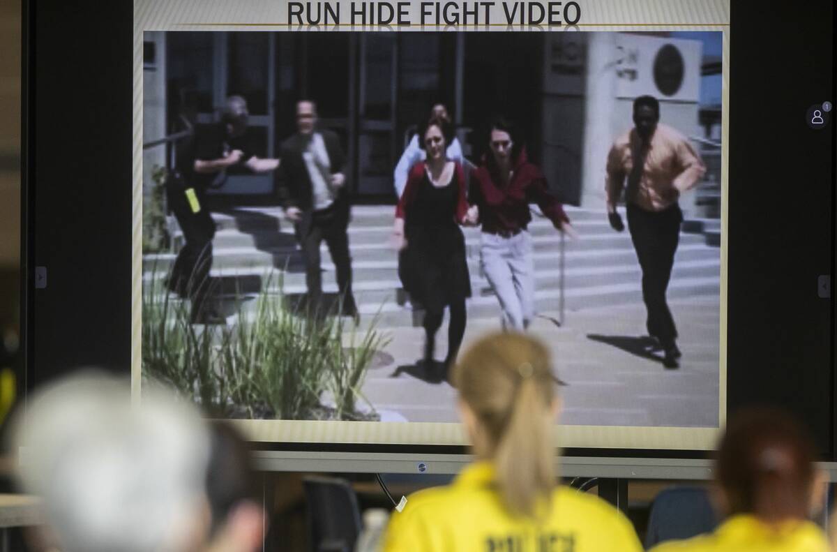 Attendees watch a video addressing active shooter tactics at Spring Valley High School in June ...