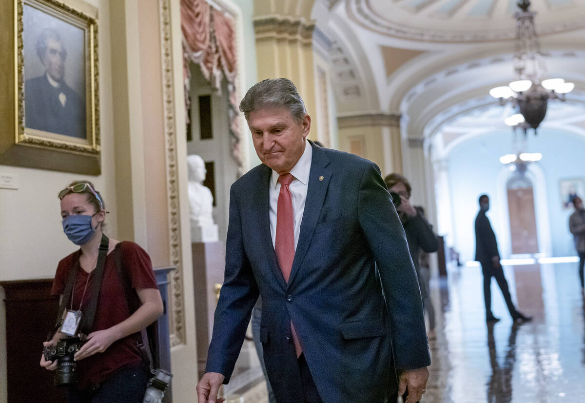 FILE - Sen. Joe Manchin, D-W.Va., walks to a caucus lunch at the Capitol in Washington, Dec. 17 ...
