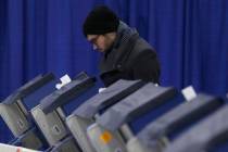 In this Tuesday, March 13, 2018 photo, Chicago resident Kurt Kamrath casts his ballot in Illino ...