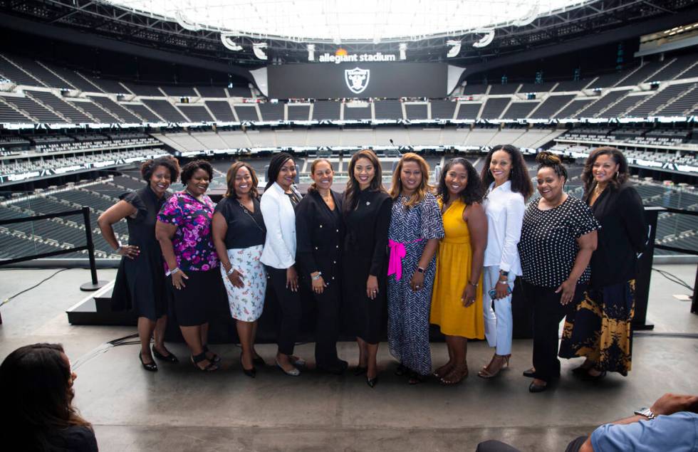 Raiders team president Sandra Douglass Morgan, center, poses with friends and loved ones after ...